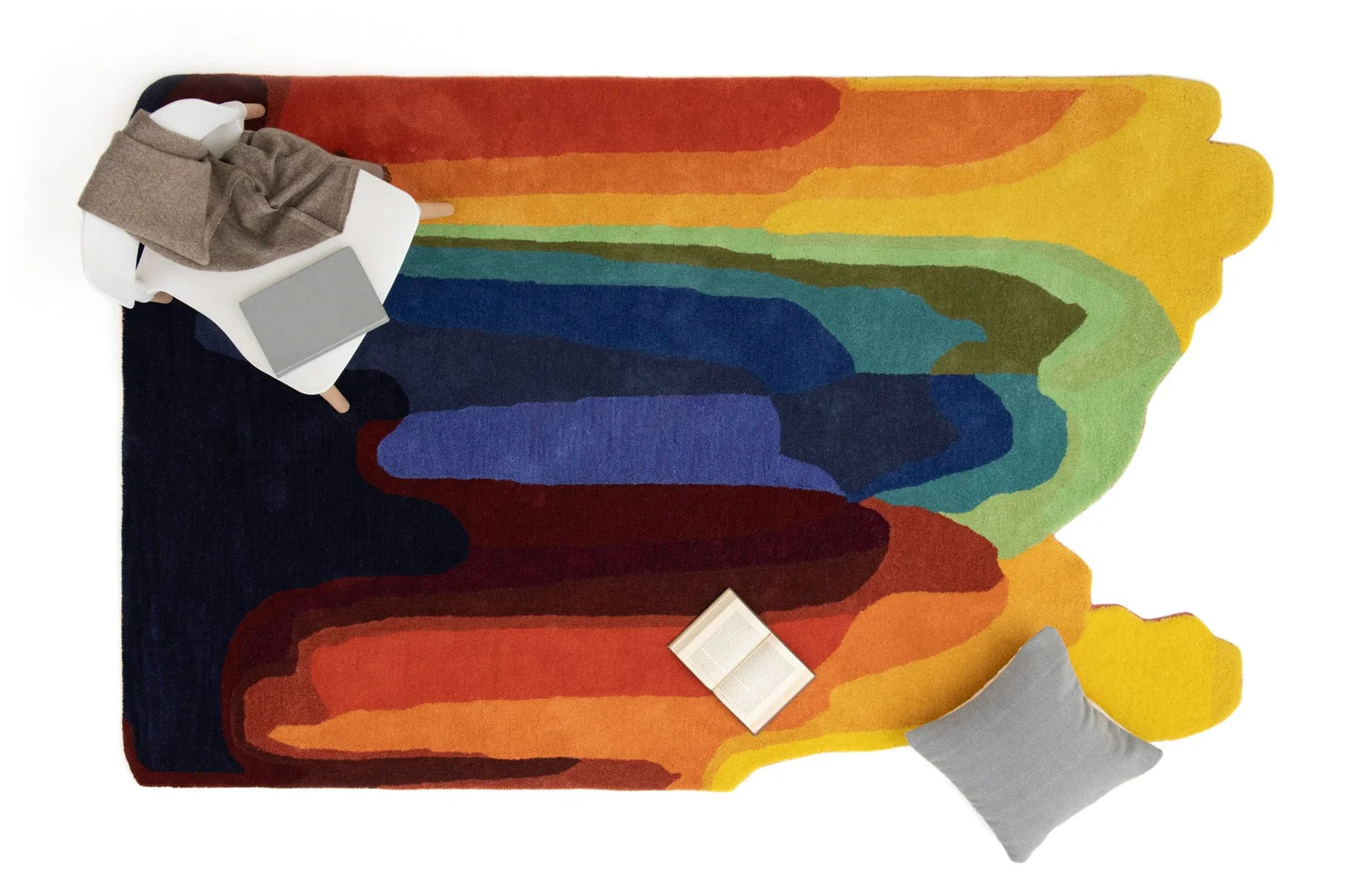 Colorful abstract rug with geometric patterns and cushions.